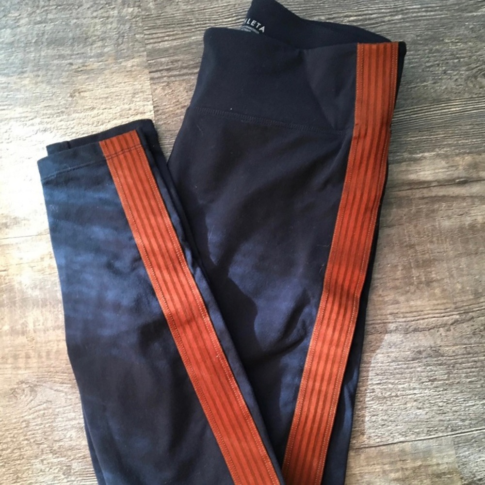 Athleta navy leggings with burnt orange stripe.